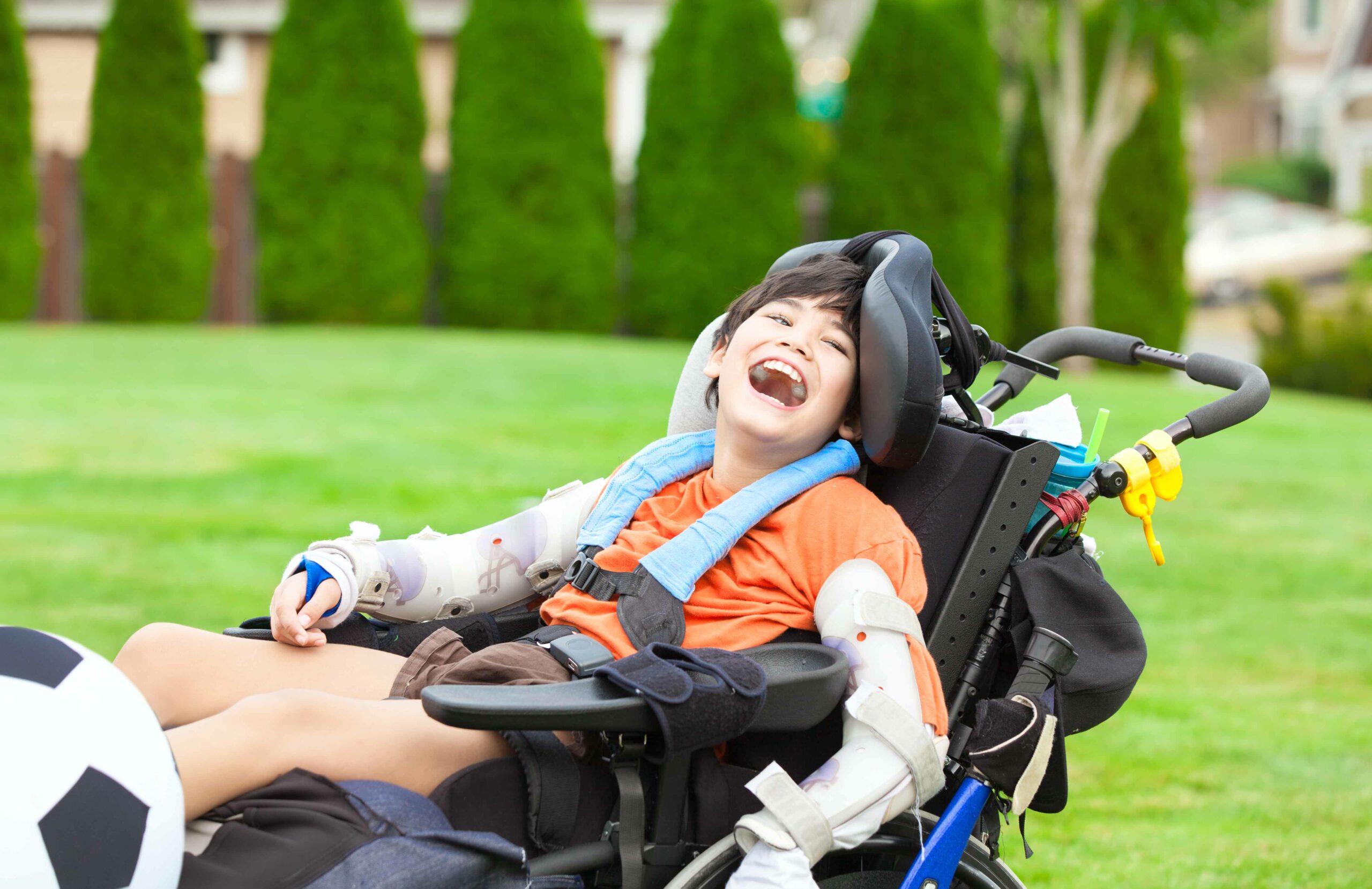 Child smiling in a wheelchair